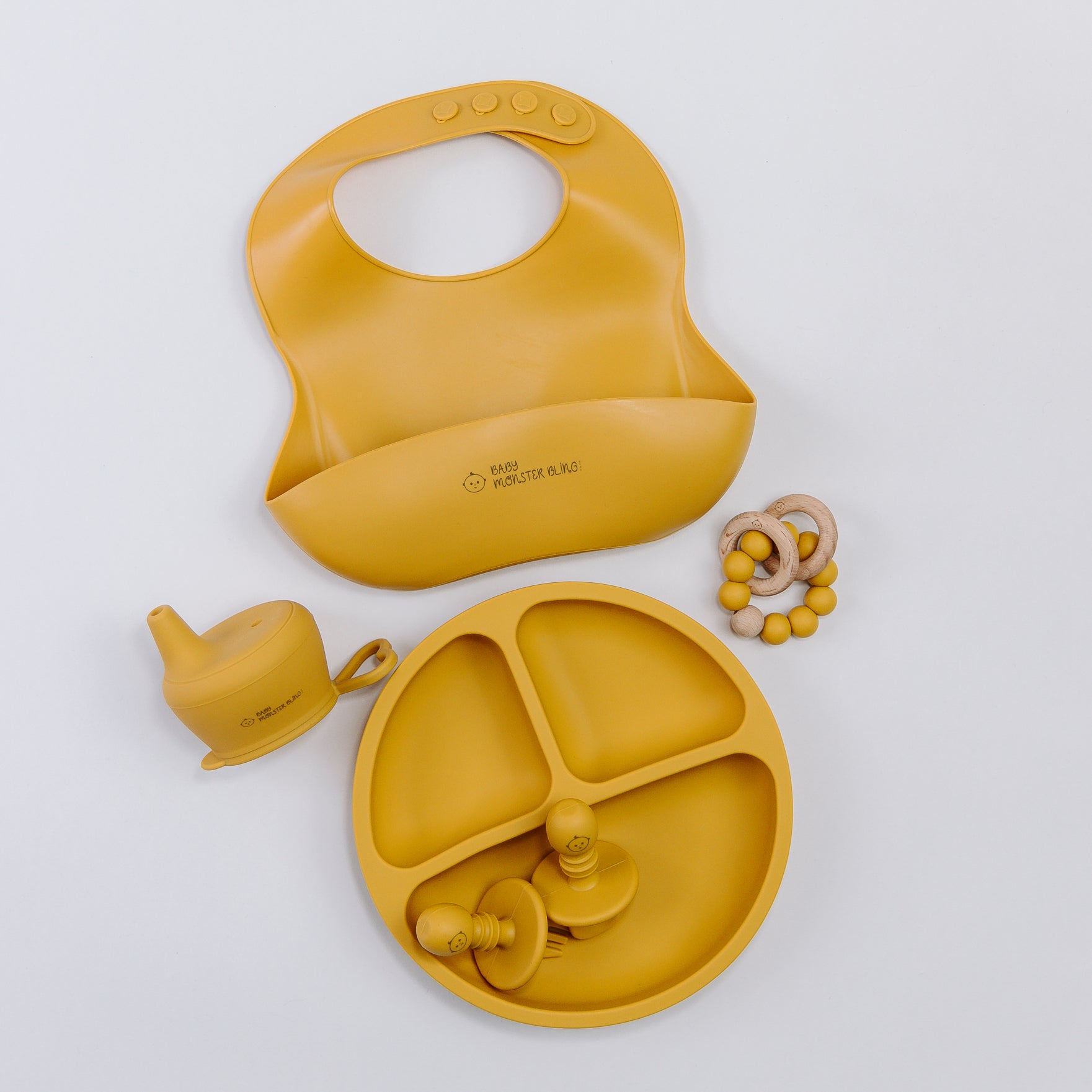 Meal set including bib, plate, utensils, silicone lids, teething rattle